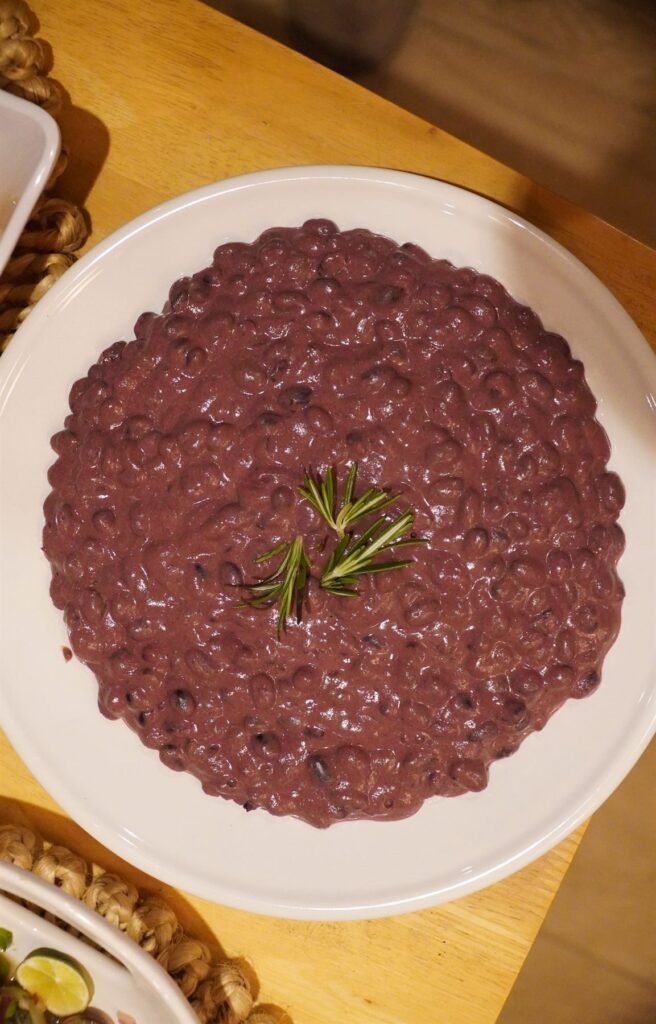Deep red beetroot risotto finished with a sprig of rosemary