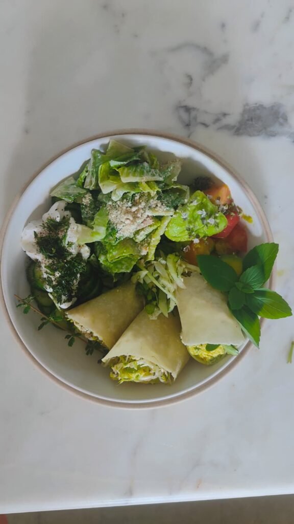 Bowl of crisp cos lettuce with shaved cheese and herb dressing