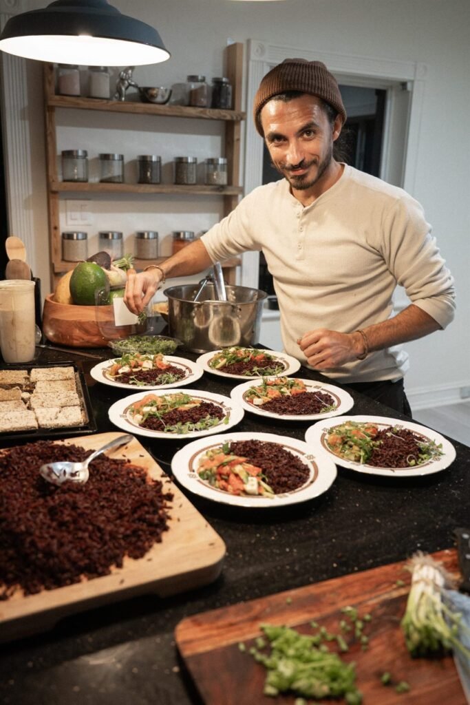 Chef Bruno Di Benedetto adding finishing garnishes to plated courses