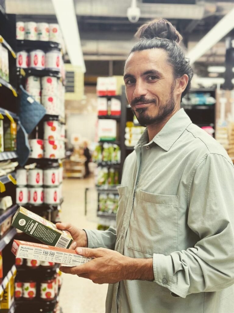 Chef Bruno Di Benedetto selecting organic produce in a Miami grocery store