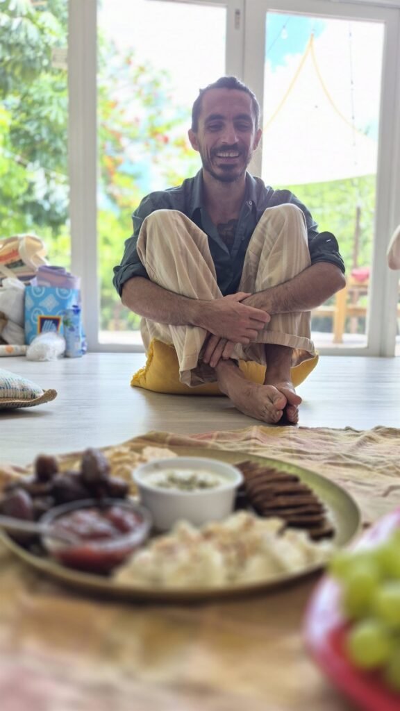 Chef seated beside a mezze spread of dips and breads