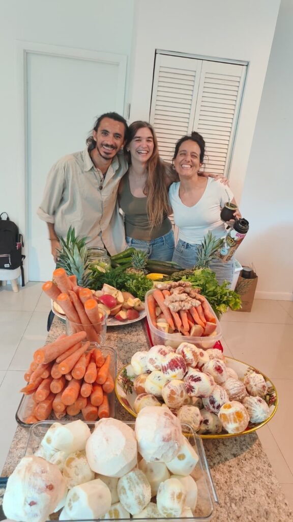 Chef Bruno Di Benedetto with two guests beside a full grazing spread of platters