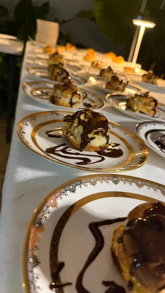 Plated dessert course finished with balsamic reduction