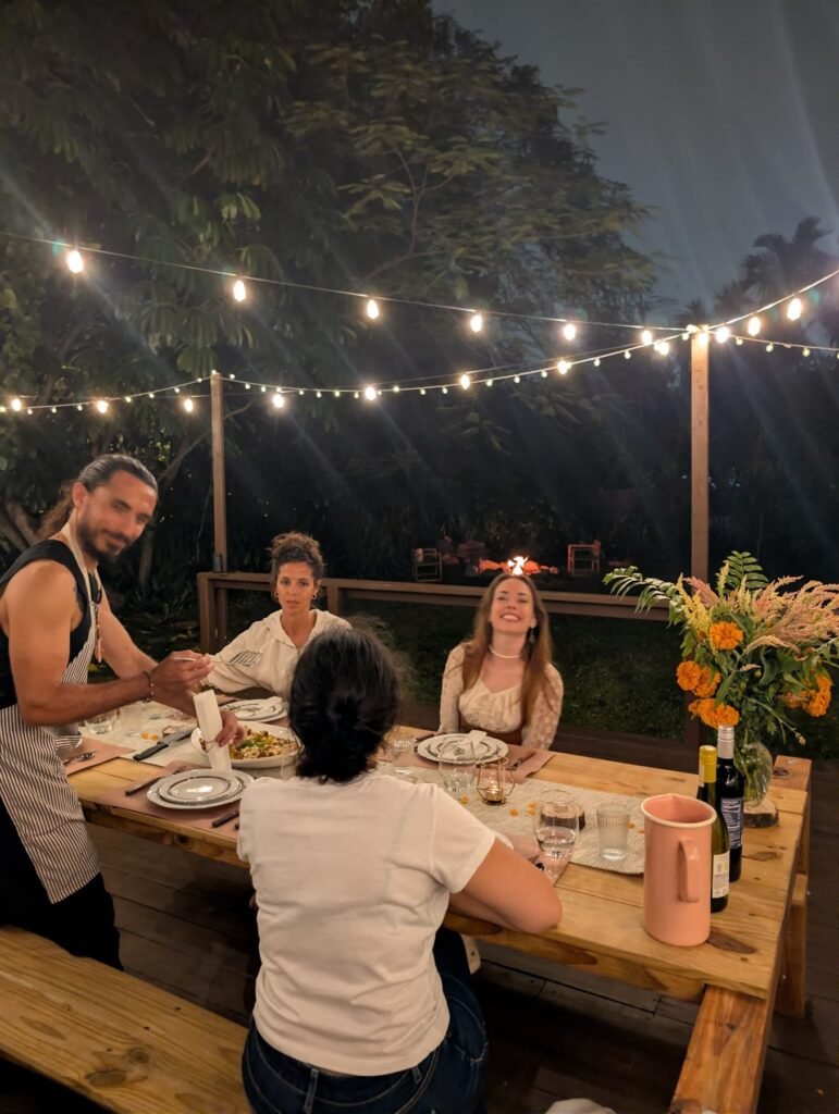 Private dinner set up in a garden under string lights