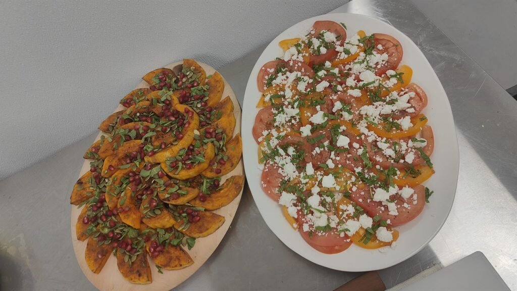 Two flatbreads topped with tomato, feta and herbs