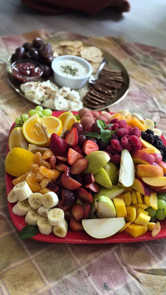 Round platter of fresh fruit, berries and soft cheeses