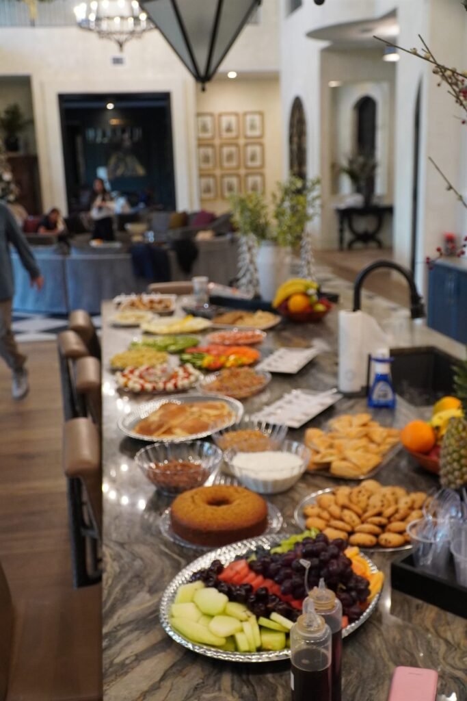 Grazing table spread with pastries, fruit, cheeses and dips