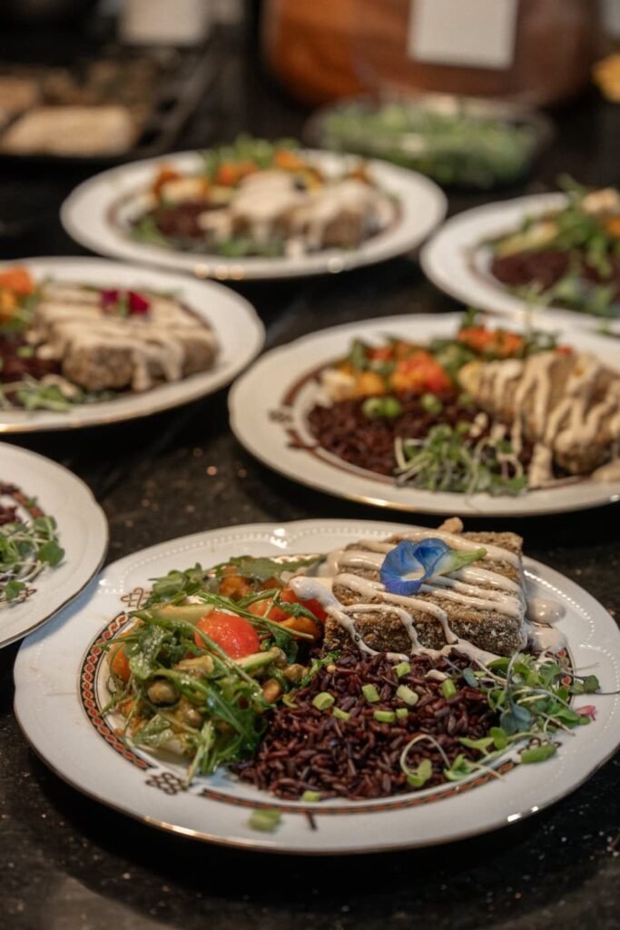 Several plated dinner courses lined up ready to be carried to the table