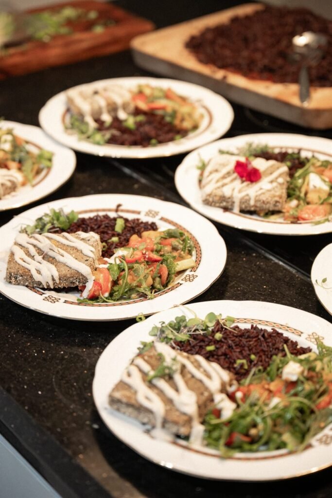 A row of identical plated courses prepared for a private dinner