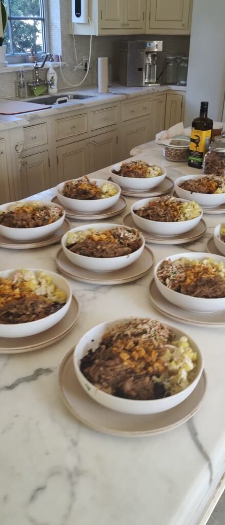 Prepared bowls lined up on a kitchen counter ready for a client