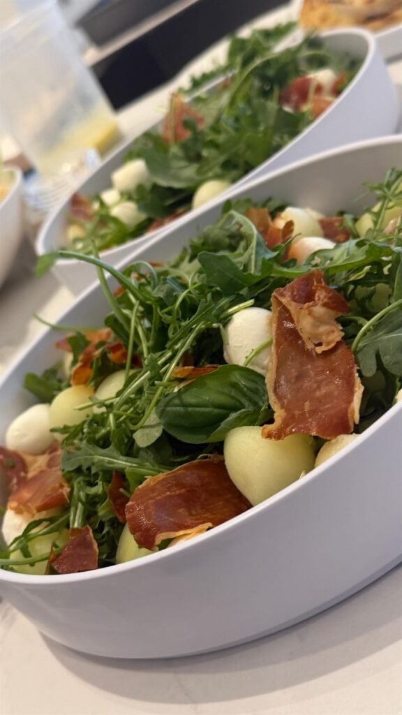 Salad bowl of arugula, prosciutto and marinated bocconcini