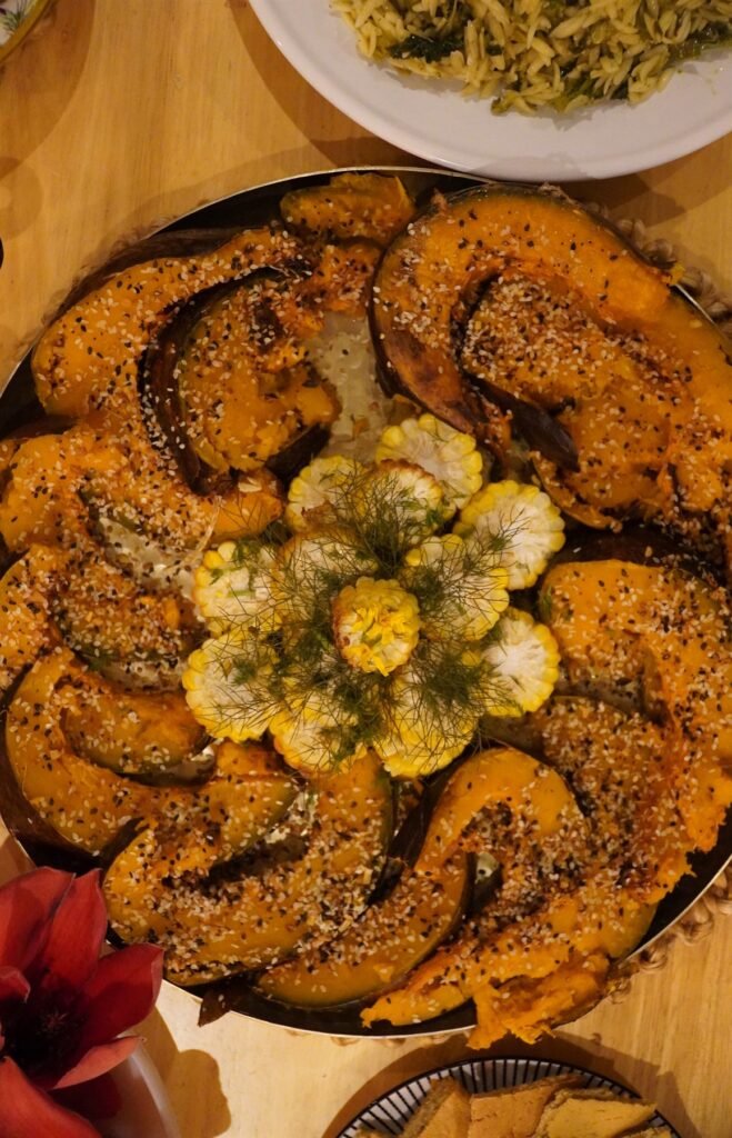 Platter of roasted squash wedges with seeds and herbs