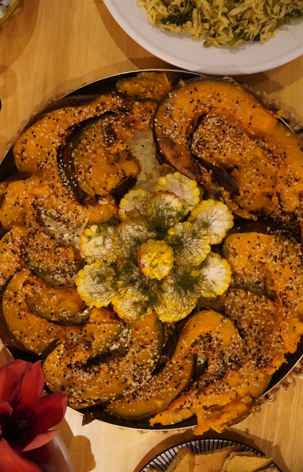 Platter of roasted squash wedges with seeds and herbs