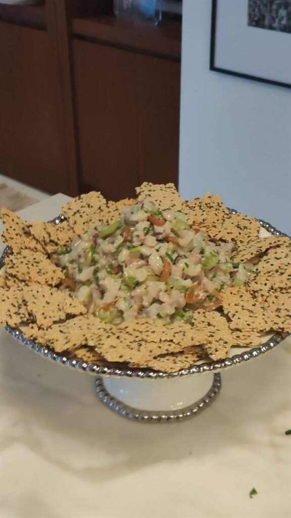 Cake stand of crackers topped with chopped salad