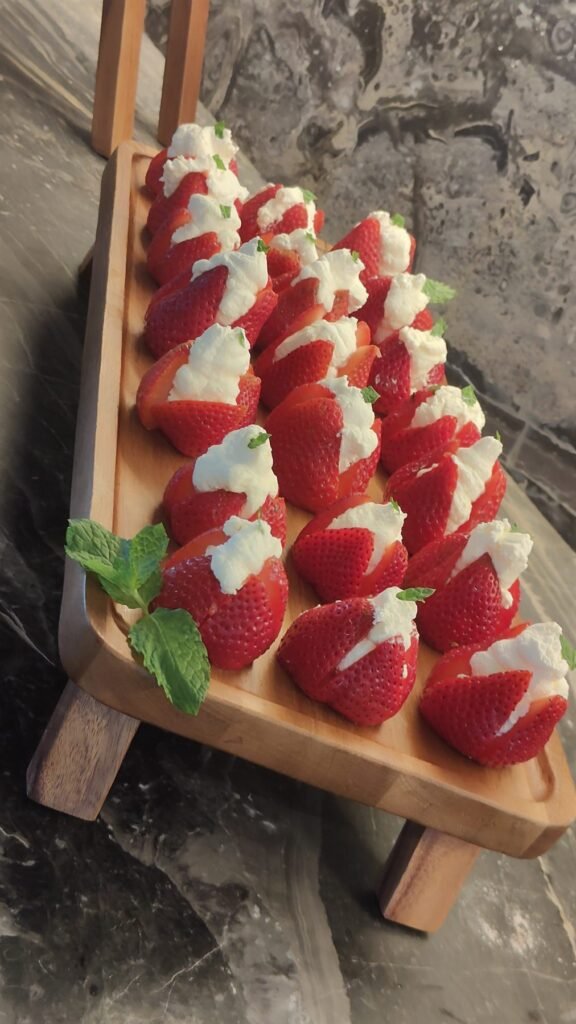 Chocolate-dipped strawberries arranged on a wooden board